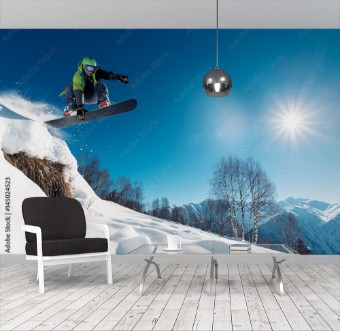 Picture of Snowboarder is jumping with snowboard